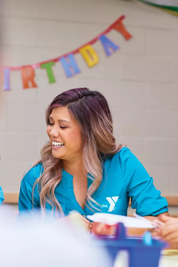 A woman sitting at a birthday party