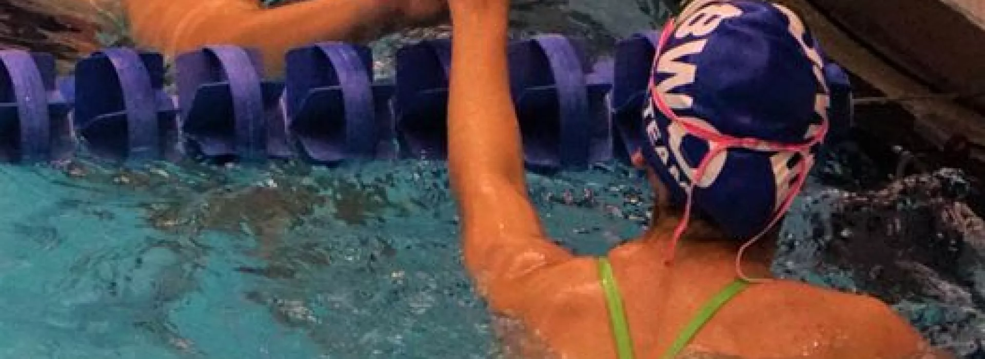 Swim Team members celebrating in the pool